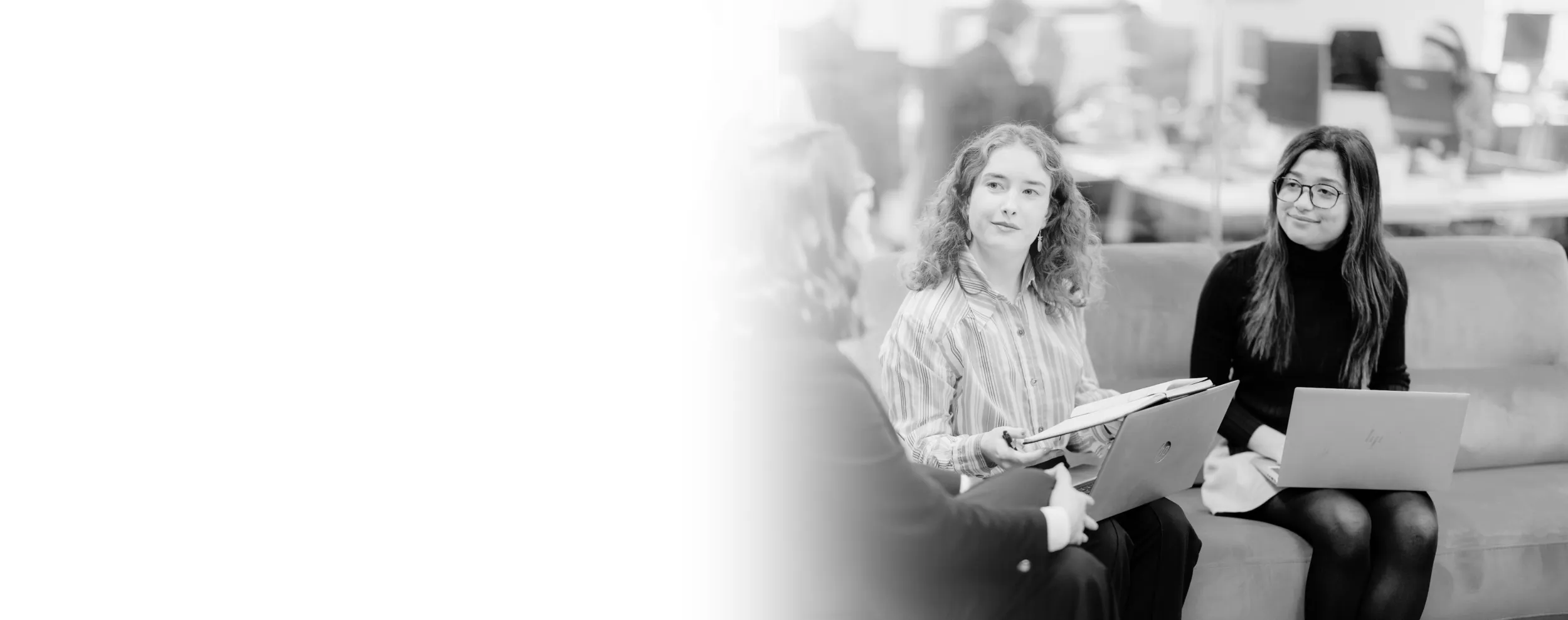 Three women talking to one another.